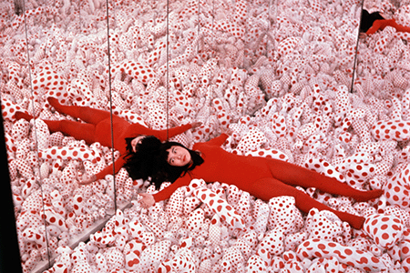 Yayoi Kusama in her Phalli's Field infinity room in 1965 Image: Eikoh Hosoe/Courtesy of Ota Fine Arts, Tokyo/Singapore; Victoria Miro, London; David Zwirner, New York Image and Artwork: © YAYOI KUSAMA